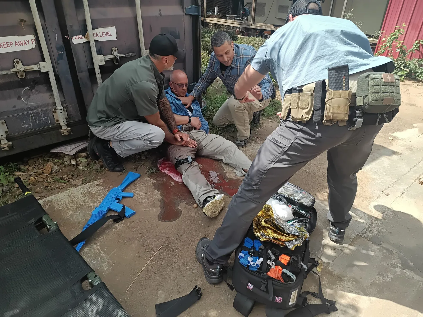Instructors treating a simulated leg bleed during training
